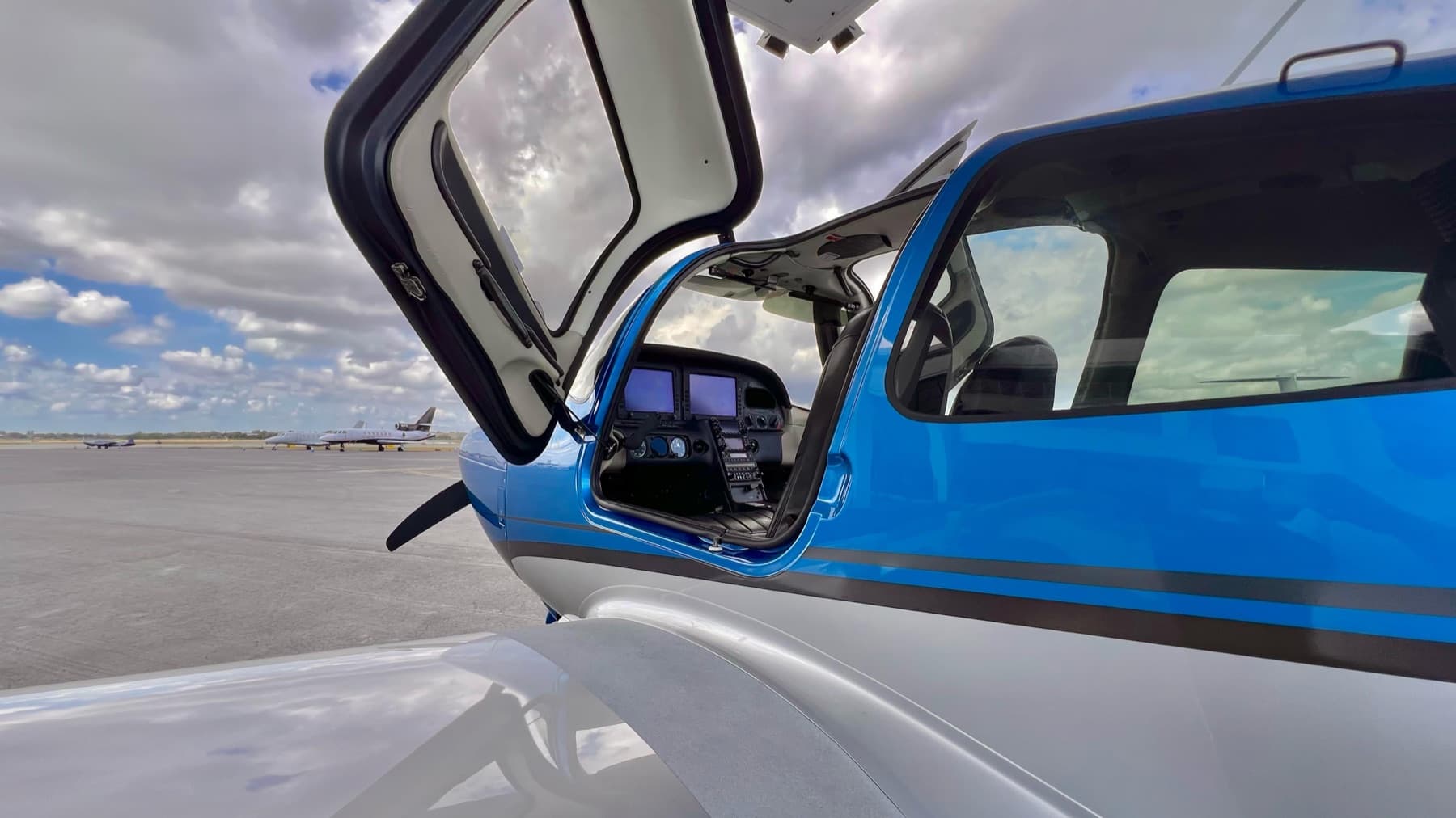 Cirrus SR-20 cabin door open showing the glass cockpit